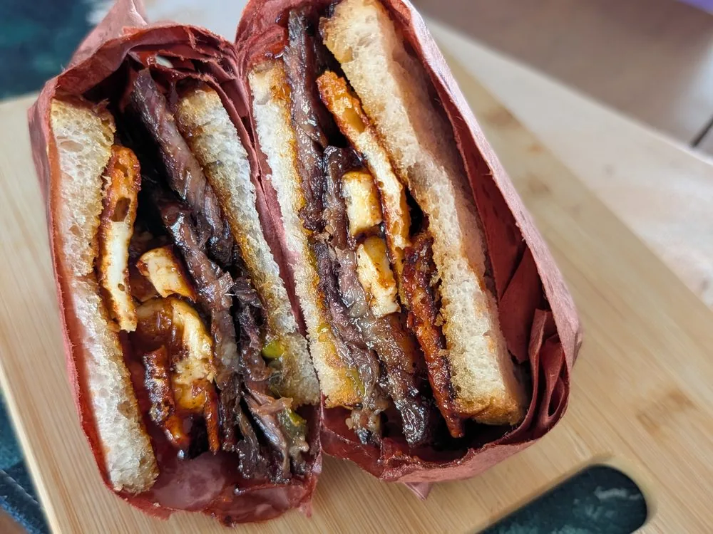 Smoked brisket sandwich, cut to show the layers