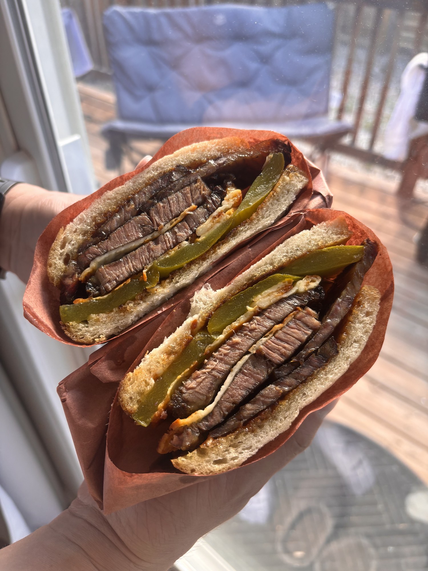 The Oregon Gold Rush brisket sandwich, cut in half and held up to the light