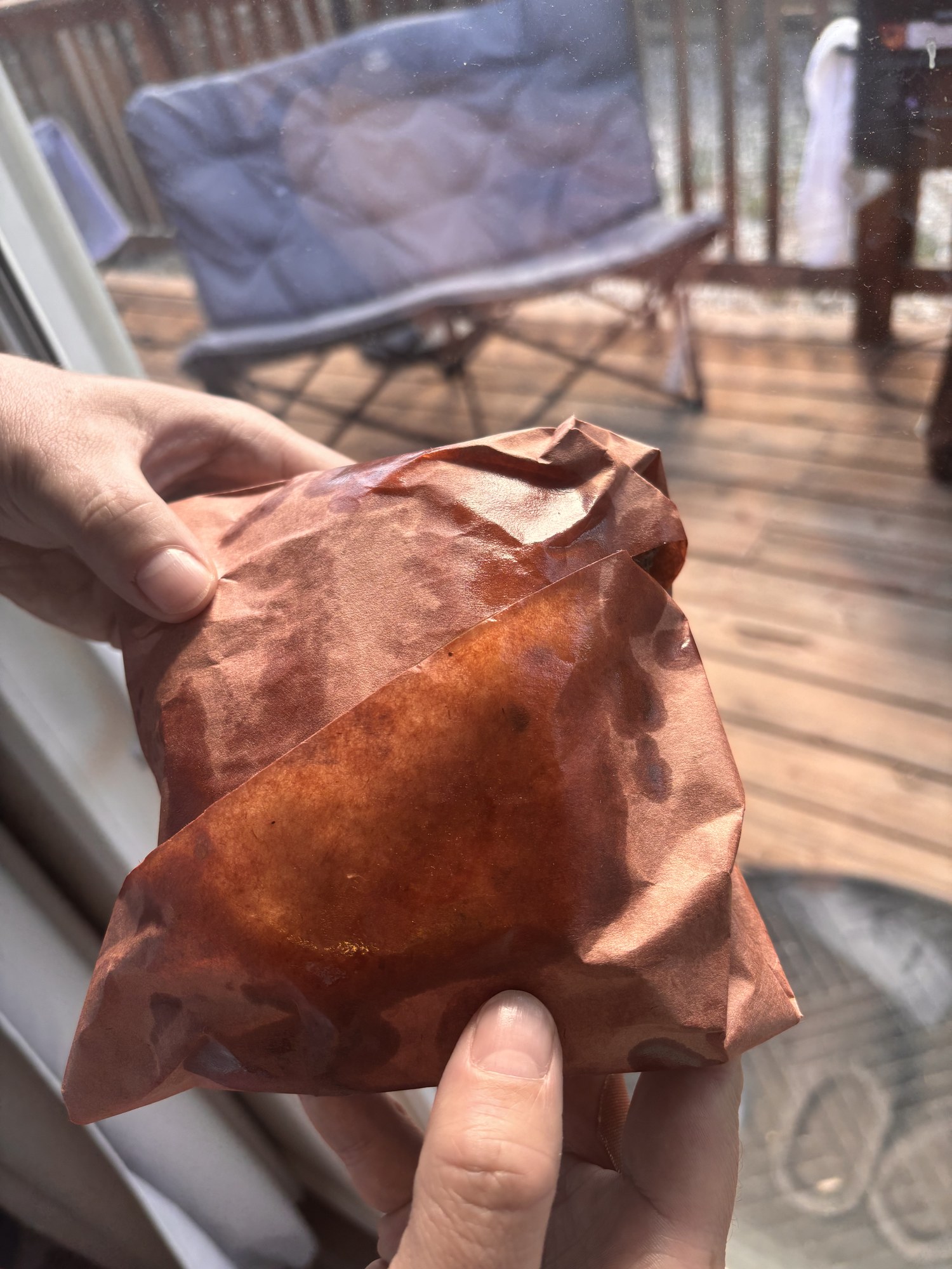 The sandwich wrapped in pink butcher paper, ready to carry out